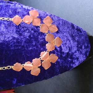 Pretty in pink statement necklace with goldtone chain lobster clasp.